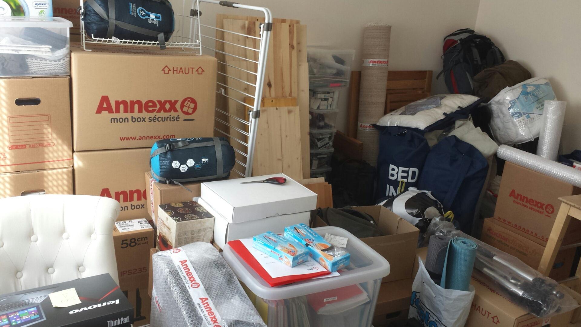 A room filled with cardboard boxes, furniture and other belongings