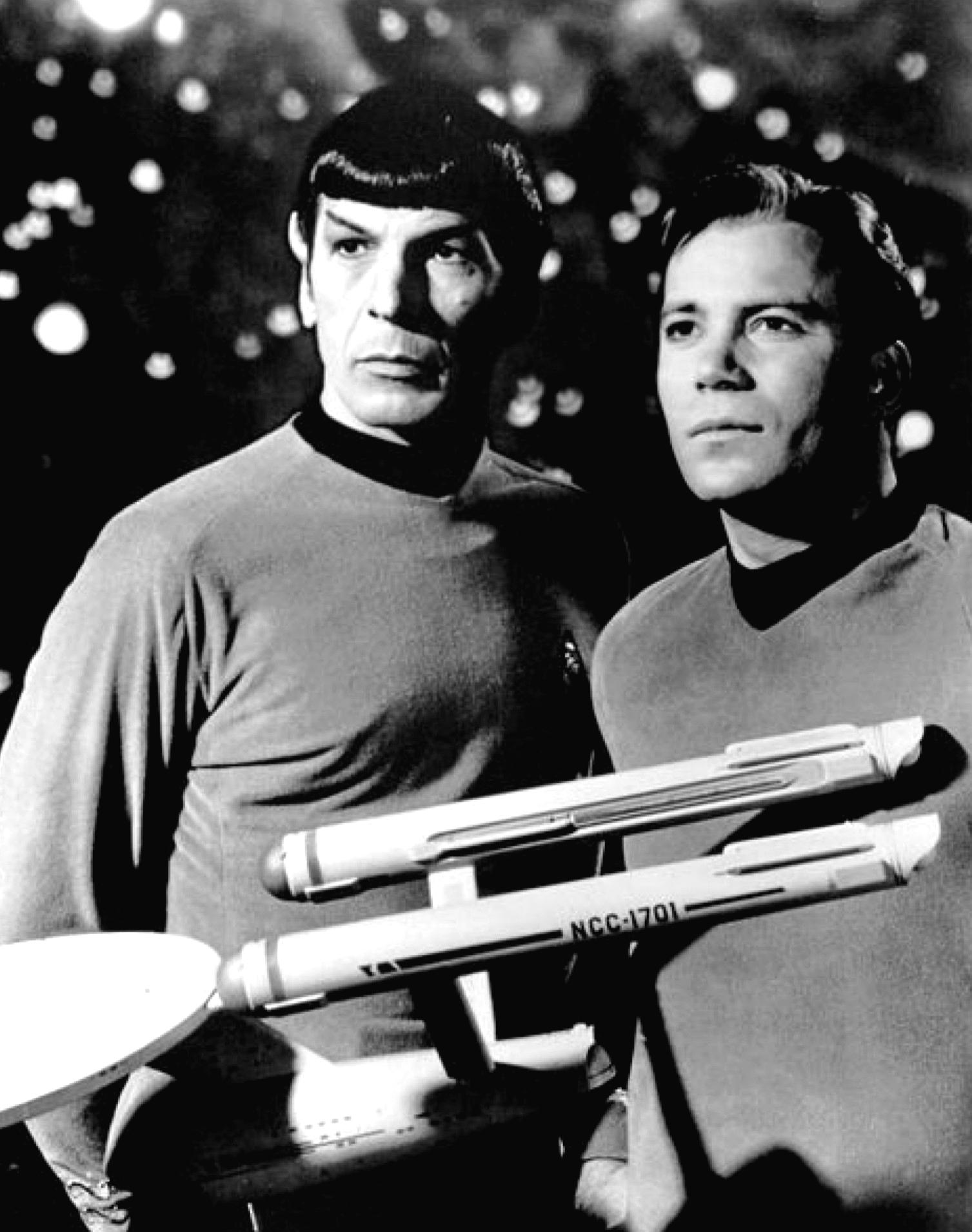 An image of Leonard Nimoy and Willian Shatner standing side by side as Spock and Kirk from the Star Trek series. A model of the star ship Enterprise is in the foreground.
