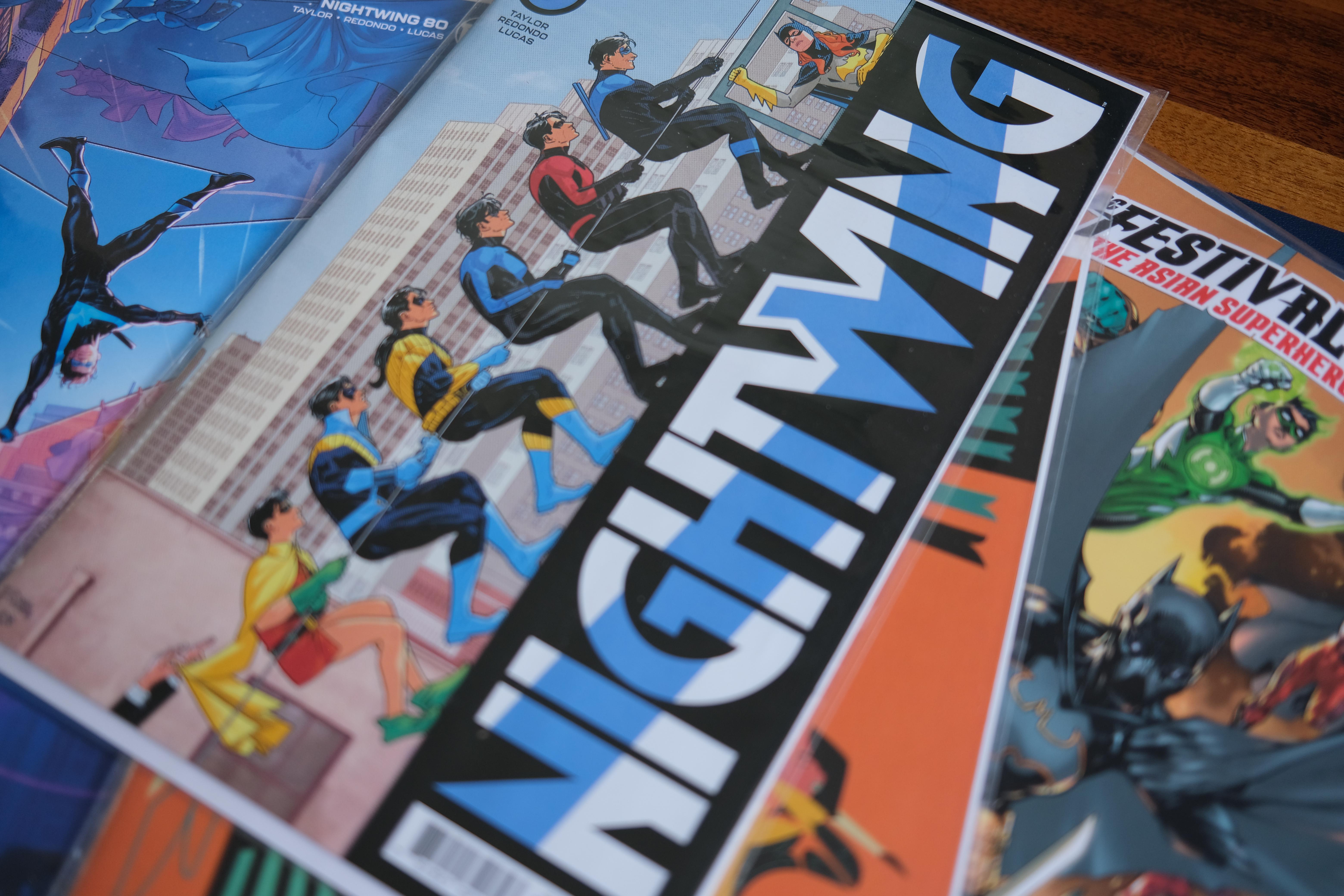 Photograph of American comic books, including a few issues of Nightwing from DC Comics.